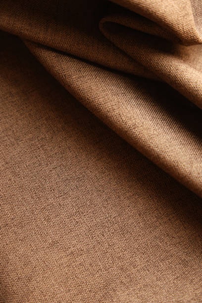 rown woven fabric showing detailed close-up of its soft surface and weave.