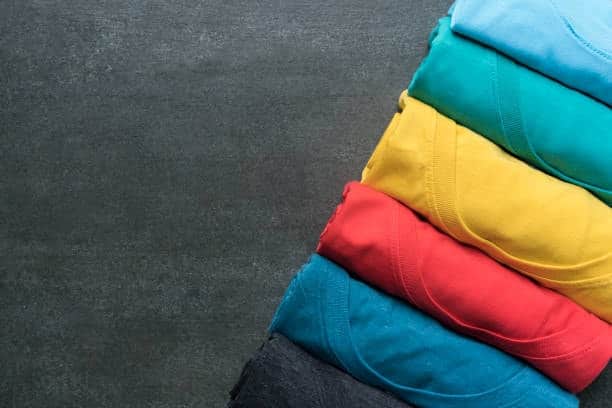 Folded colorful cotton T-shirts showing fabric choices for casual clothing.