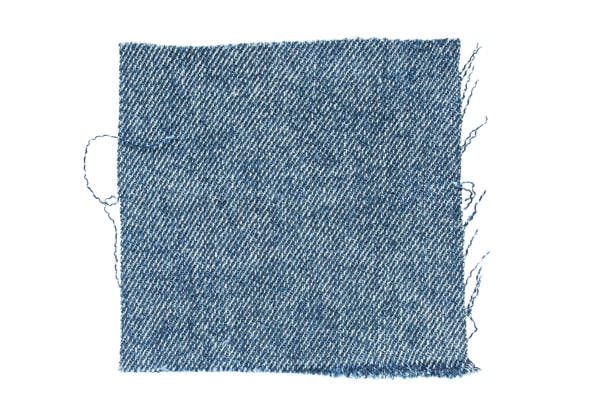 Close-up view of a denim fabric swatch sample.