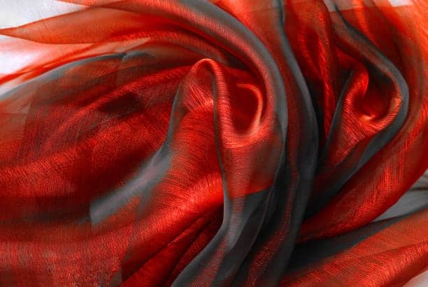 Shiny red and black chiffon fabric with a rich flowing texture.
