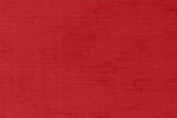 Rich red velvet fabric, showcasing a luxurious synthetic cloth fabric type commonly used in upscale apparel.