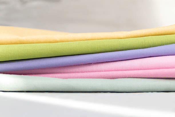 Stack of colorful fabrics used in clothing manufacturing