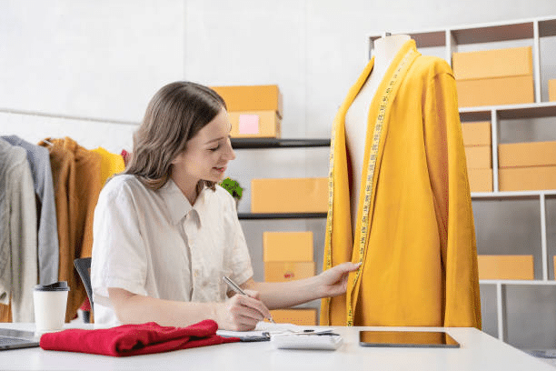Fashion designer adjusting tailored clothing on mannequin during fitting stage